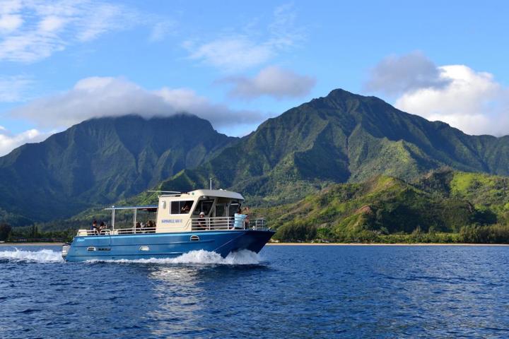 a small boat in a body of water with a mountain in the background