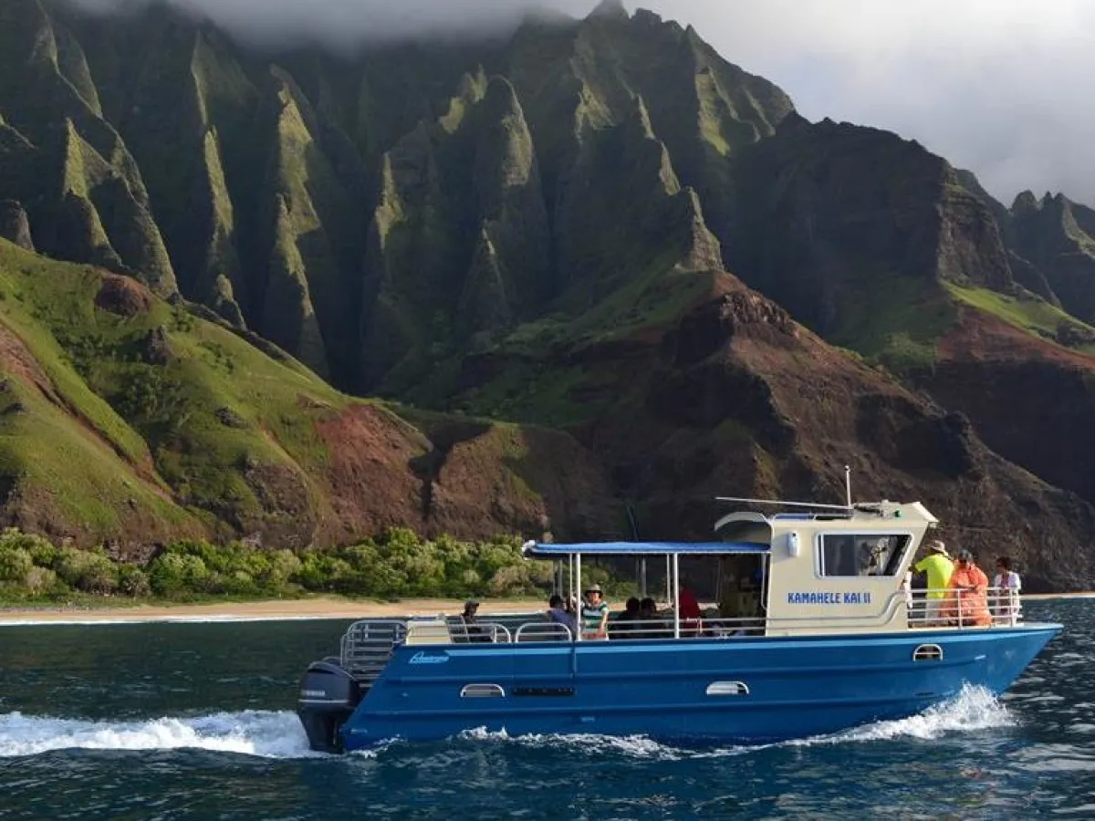 a small boat in a body of water with a mountain in the background